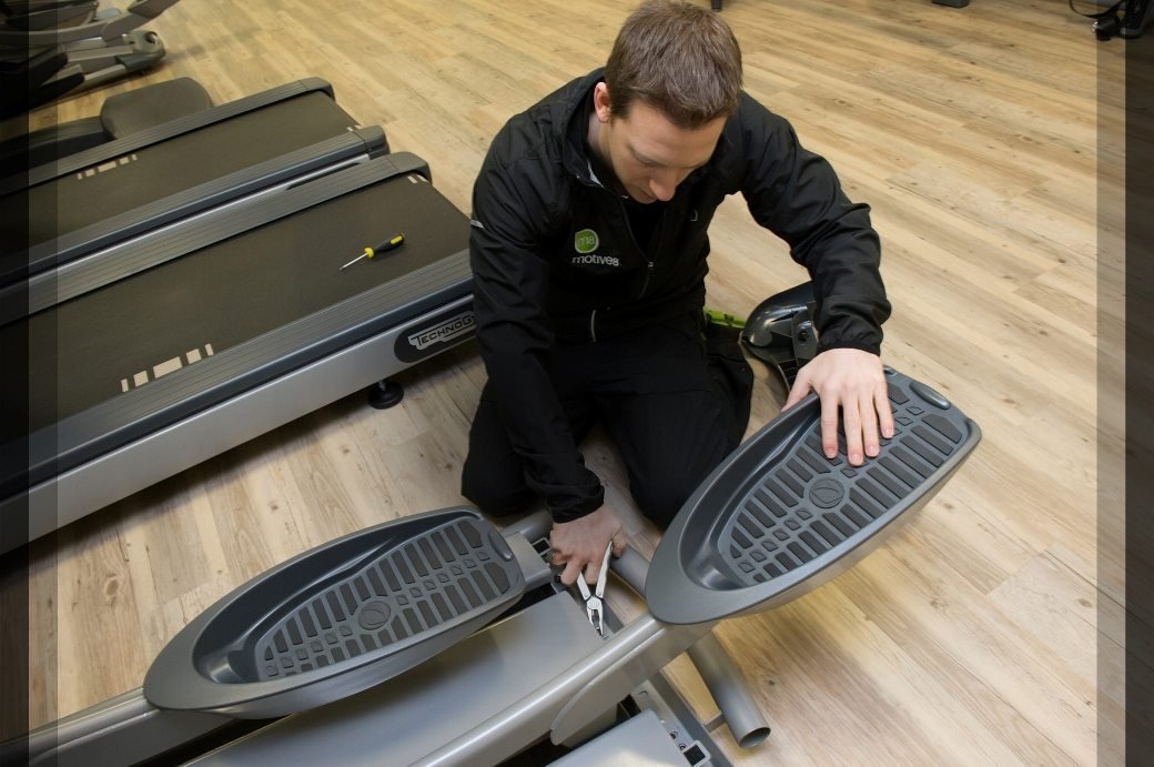Man carrying out gym risk assessment